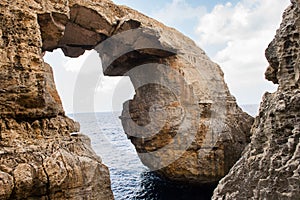 Wied il Mielah canyon, natural arch over the sea. Gozo, Malta