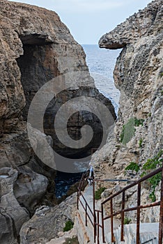 Wied il Mielah canyon, natural arch over the sea. Gozo, Malta