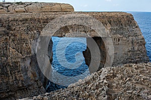 Wied il Mielah canyon, natural arch over the sea. Gozo, Malta