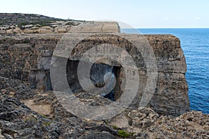 Wied il Mielah canyon, natural arch over the sea. Gozo, Malta