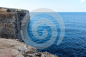 Wied il Mielah canyon, natural arch over the sea. Gozo, Malta