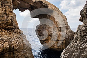 Wied il Mielah canyon, natural arch over the sea. Gozo, Malta