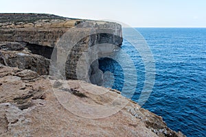 Wied il Mielah canyon, natural arch over the sea. Gozo, Malta