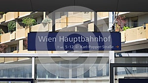 Wien Hauptbahnhof sign (meaning main railway station in German) match cut in Vienna, Austria central station.