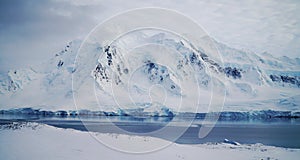 Wiencke Island / Dorian Bay landscape with snowy mountains in Antarctica.