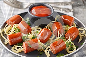 Wiener and Noodle Spider Snacks with ketchup close-up in a plate. Horizontal