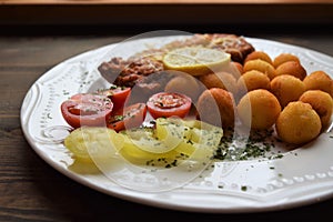 Wiener schnitzel with potato croquettes and lemon freshened