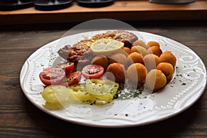 Wiener schnitzel with potato croquettes and lemon freshened