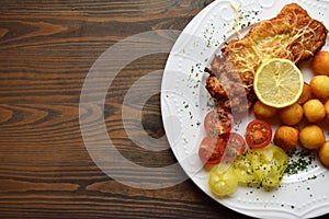 Wiener schnitzel with potato croquettes and lemon freshened