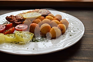 Wiener schnitzel with potato croquettes and lemon freshened