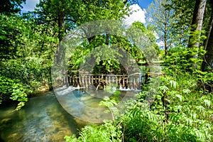 Wier with fast flowing water photo