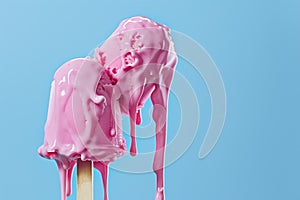 Wierd home made strawbery ice cream on the stick isolated on a blue background photo