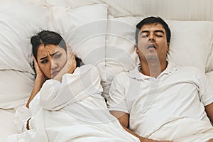 Wife can`t sleep Because the husband snores loudly on bedroom in morning.