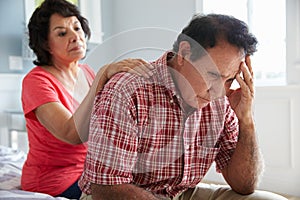 Wife Comforting Senior Husband Suffering With Dementia