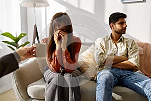 Wife crying, husband revert eyes during psychotherapy