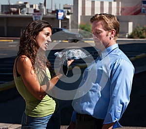 Wife explains to husband about his tie.