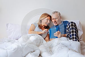 Wife feeling entertained while watching comedy with husband photo