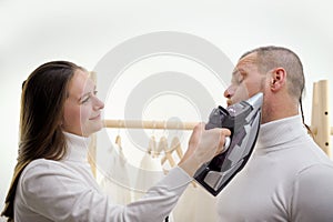 wife forces husband to iron clothes Woman slapping her boyfriend. isolated on a white background