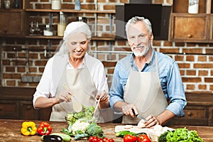 Wife and husband cooking salad