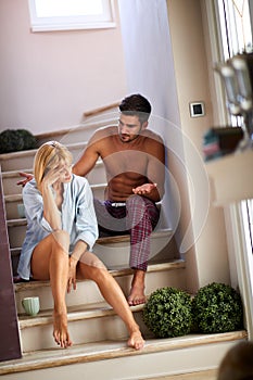 Wife and husband having discussion on stairs