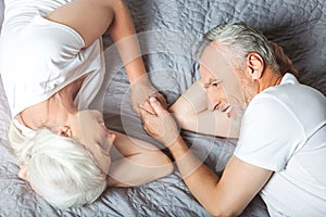 Wife and husband lying on the bed