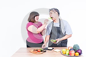 wife and husband Obese are smiling and happiness To cooking and eating a hamburger That they are prepared