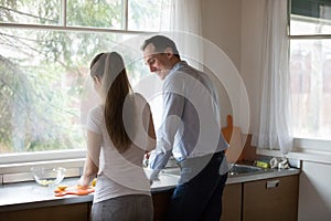 Wife and husband preparing food together in the kitchen