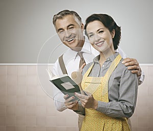 Wife and husband reading a cookbook together