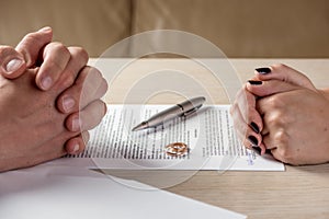 Wife and husband signing divorce documents or premarital agreement