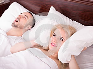 Wife with husband snoring in sleep