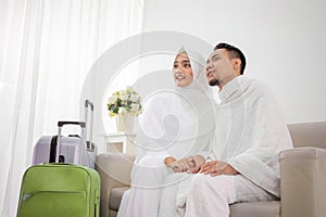 Wife and husband in white traditional clothes for Ihram