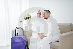 Wife and husband in white traditional clothes for Ihram