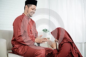 A wife kneel bow to his husband for apologize