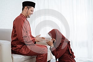 A wife kneel bow to his husband for apologize