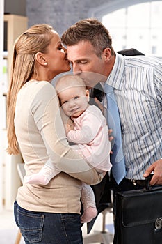 Wife and little girl greeting father arriving home