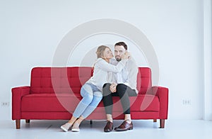 Wife reconcile her touchy husband and hugging couple in love at the living room,Positive attitude emotions