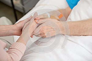 Wife with senior man in hospital