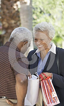 Wife showing husband contents of bag photo