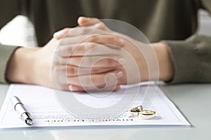 Wife signs divorce decree form with ring