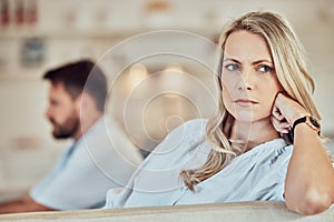 Wife sulking after fight with her husband and giving the silent treatment. Caucasian woman sitting on a sofa and