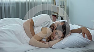 Wife thoughtfully lying in bed, woman keeping secret from her husband, remorse