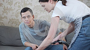 Wife vacuums the floor and interferes with watching tv