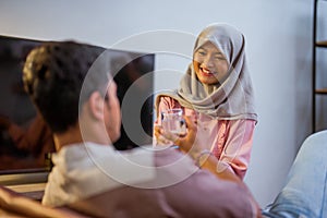 wife waking her husband up in the bed to have a breakfast photo