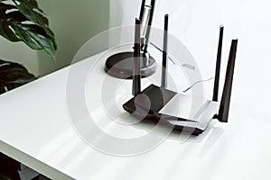 Wifi and broadband router on white table in room at the home.