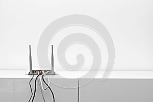 Wifi internet router on shelf in white interior