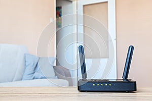 Wifi modem on table in living room. Home internet connection.