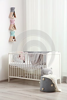 Wigwam shaped shelves over crib in room. Interior design