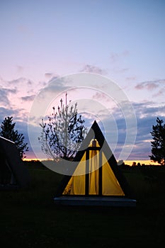 Wigwams against the sunset sky. A hause