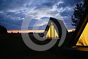 Wigwams against the sunset sky. A hause