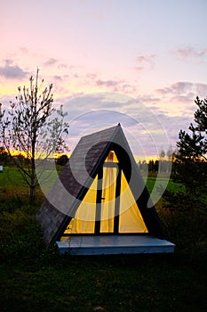 Wigwams against the sunset sky. A hause